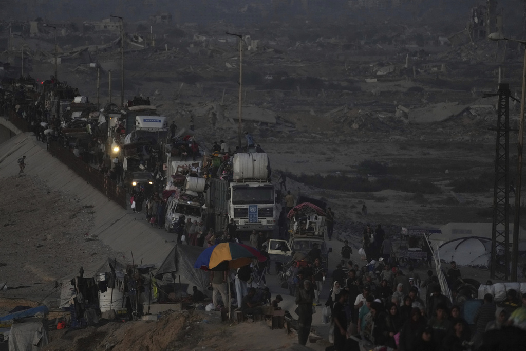 Displaced Palestinians flee Gaza City, by foot and vehicles, carrying their belongings along the coastal road in Nuseirat toward the southern Gaza Strip, Friday, Sept. 19, 2025. (AP Photo/Abdel Kareem Hana)