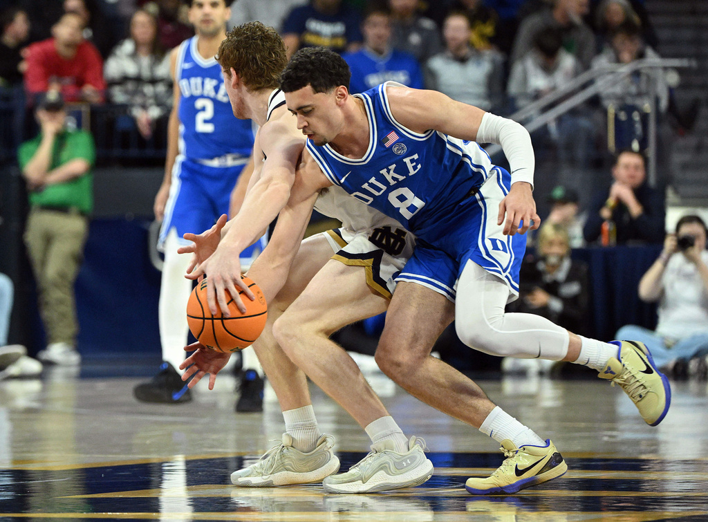 Duke guard Darren Harris (8) gets the ball away from Notre Dame forward Ryder Frost during the second half of an NCAA basketball game, Tuesday, Feb. 24, 2026, in South Bend, Ind. (AP Photo/Marc Lebryk)