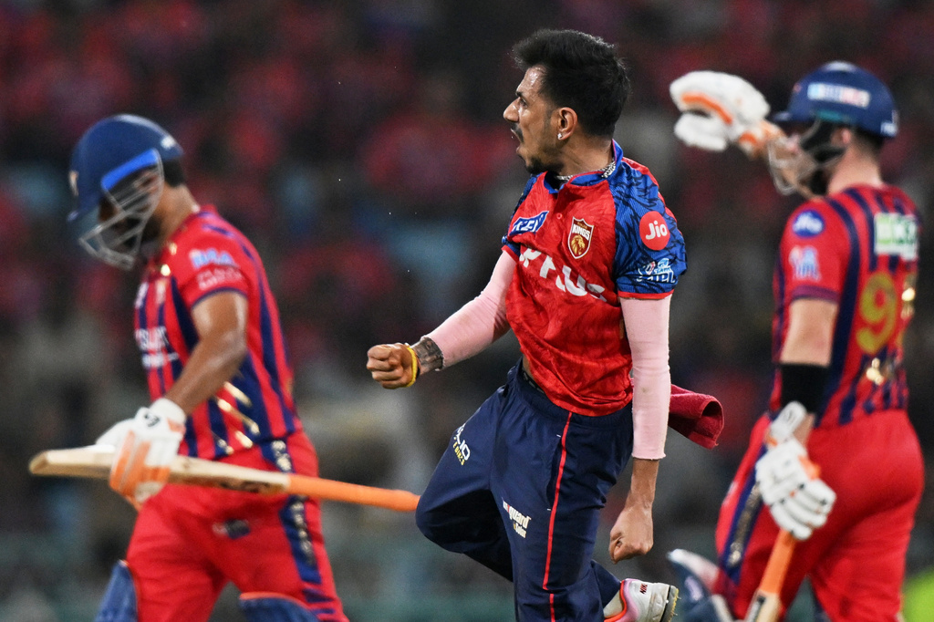 Punjab Kings' Yuzvendra Chahal, centre, celebrates the wicket of Lucknow Super Giants' captain Rishabh Pant, left, during the Indian Premier League cricket match between Lucknow Super Giants and Punjab Kings, in Lucknow, India, Saturday, May 23, 2026. (AP Photo)