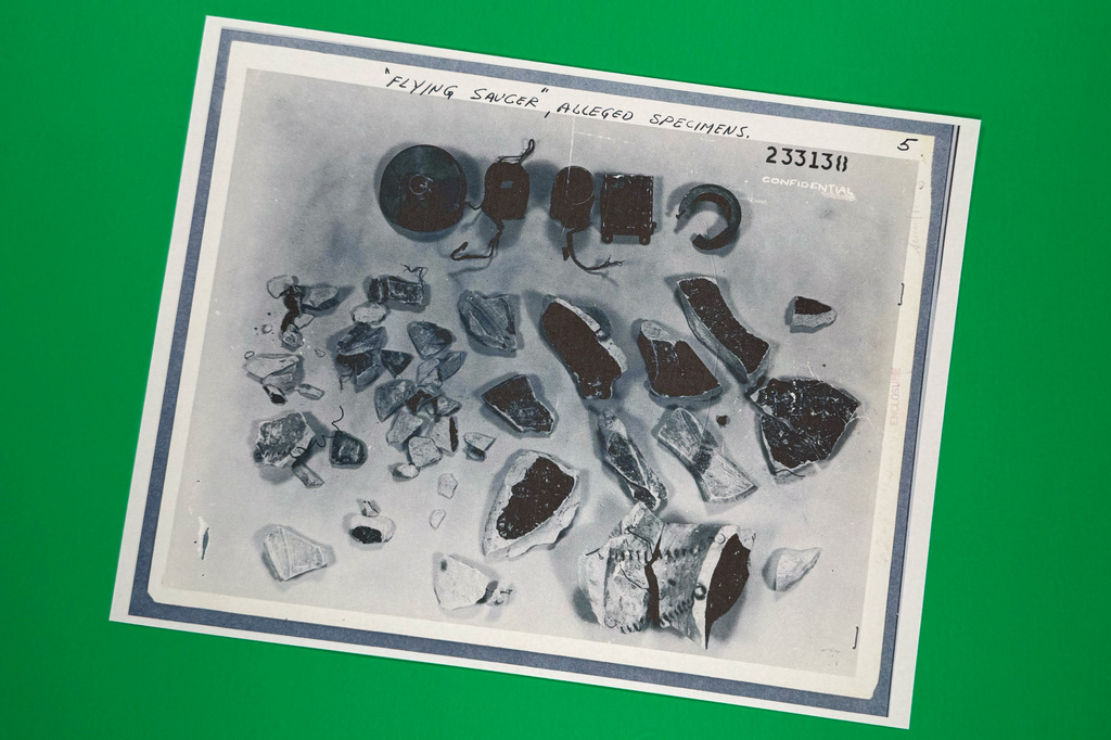 A photo of "flying saucer alleged specimens" in files on UFOs, released Friday, May 8, 2026, by the Pentagon, is photographed in Washington. (AP Photo/Jon Elswick)