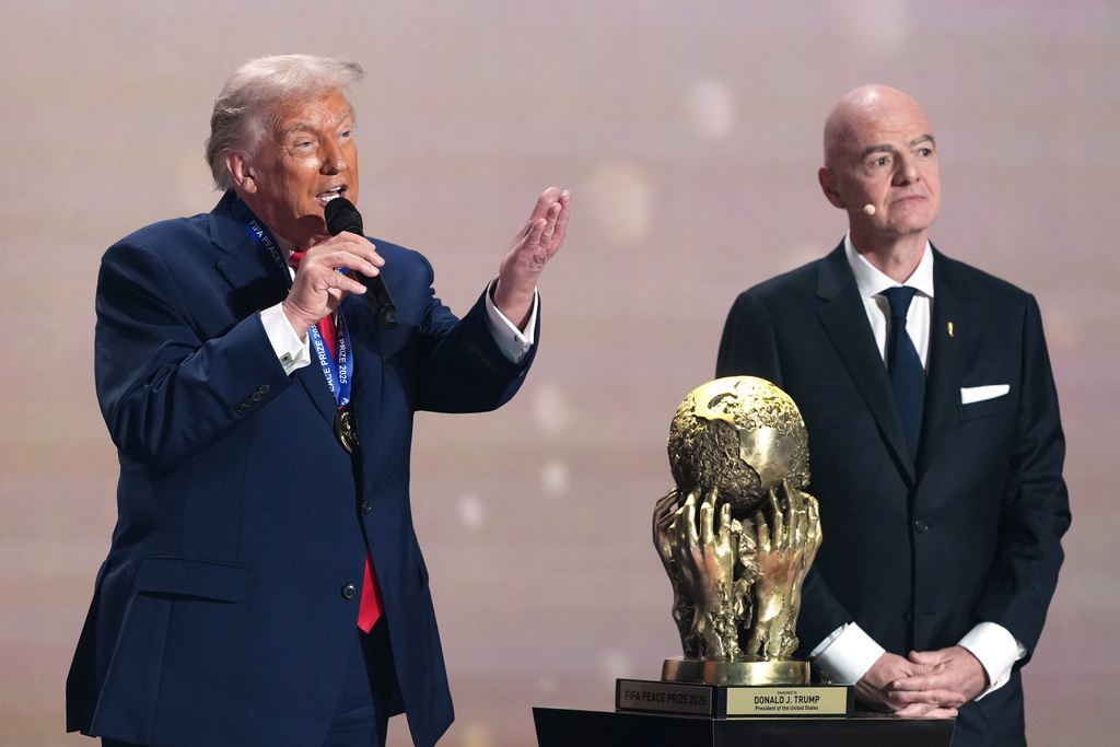 President Donald Trump speaks after being presented with the FIFA Peace Prize by FIFA President Gianni Infantino during the draw for the 2026 soccer World Cup at the Kennedy Center in Washington, Friday, Dec. 5, 2025. (AP Photo/Stephanie Scarbrough, Pool)