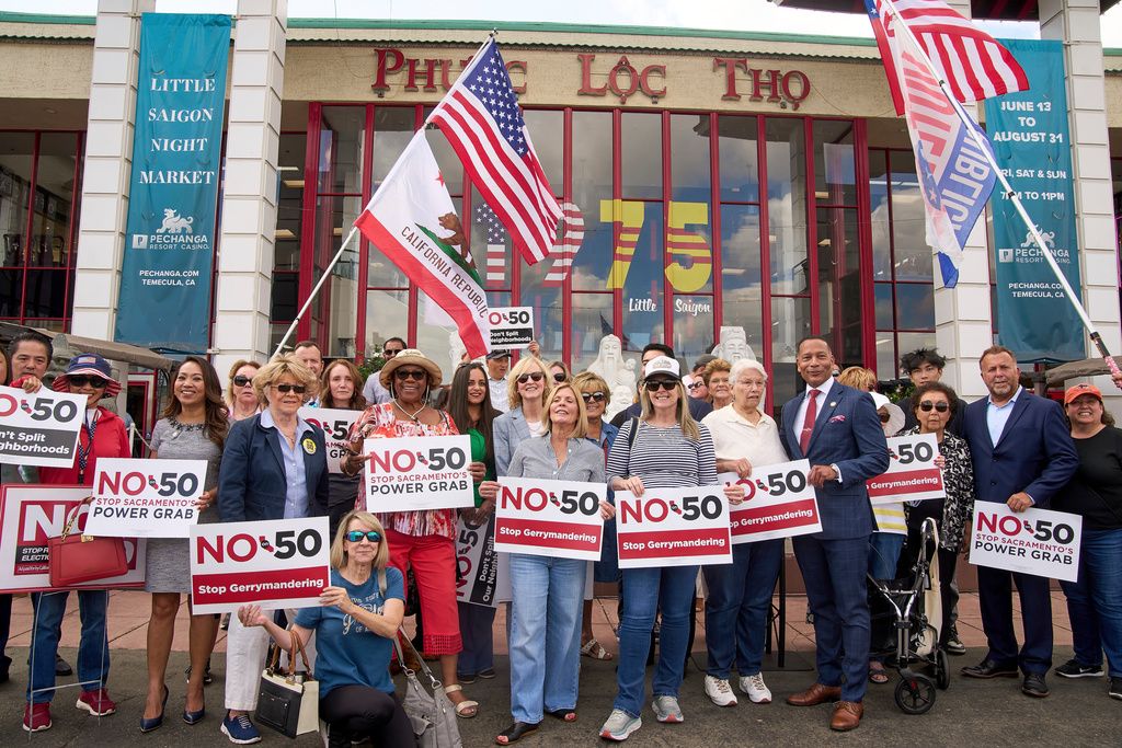 FILE - Opponents of California Proposition 50, also known as the Election Rigging Response Act, a California ballot measure that would redraw congressional maps to benefit Democrats hold a rally in Westminster, Calif., on Wednesday, Sept. 10, 2025. (AP Photo/Damian Dovarganes, File)