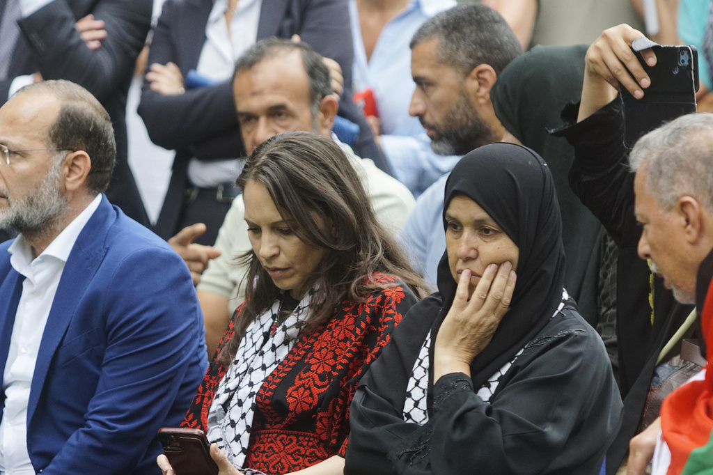 The mother, center right, of 19-year-old Palestinian woman Marah Abu Zhuri attends her funeral in Pontesserchio, near Pisa, Italy, Wednesday Aug. 20, 2025, who died there after being evacuated from Gaza. (Alessandro La Rocca/LaPresse via AP)