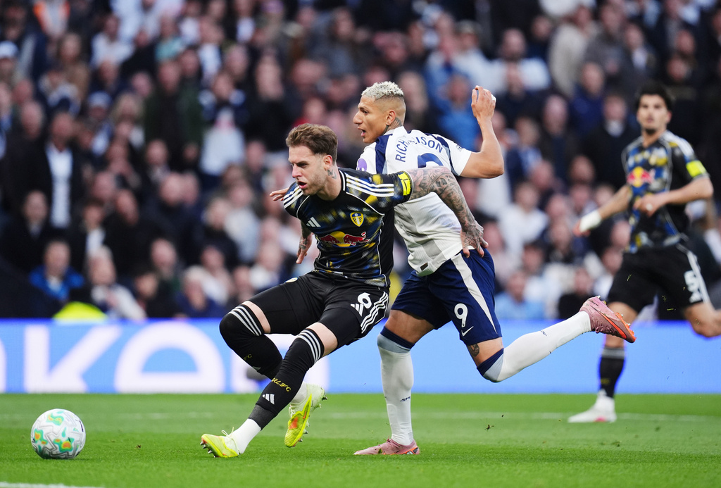 Leeds United's Joe Rodon, left, and Tottenham's Richarlison battle for the ball during the English Premier League soccer match between Totteham Hotspur and Leeds United in London, Monday, May 11, 2026. (John Walton/PA via AP)