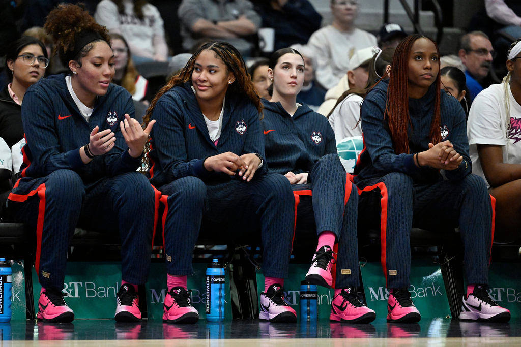 UConn starter Sarah Strong, second from left, sits out for a day of rest on the bench with teammates Ice Brady, left, Morgan Cheli, second from right, and Blanca Quiñonez, right, durinig the first half of an NCAA college basketball game against Butler, Saturday, Feb. 7, 2026, in Hartford, Conn. (AP Photo/Jessica Hill)