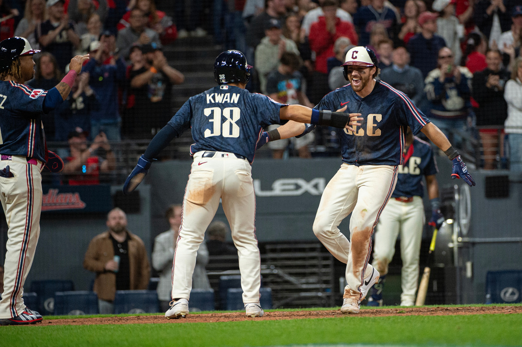 Cleveland Guardians' Daniel Schneemann, right, is greeted by Steven Kwan (38) and Jose Ramirez after hitting a grand slam home run off Baltimore Orioles relief pitcher Anthony Nunez during the seventh inning of a baseball game, Friday, April 17, 2026, in Cleveland. (AP Photo/Phil Long)