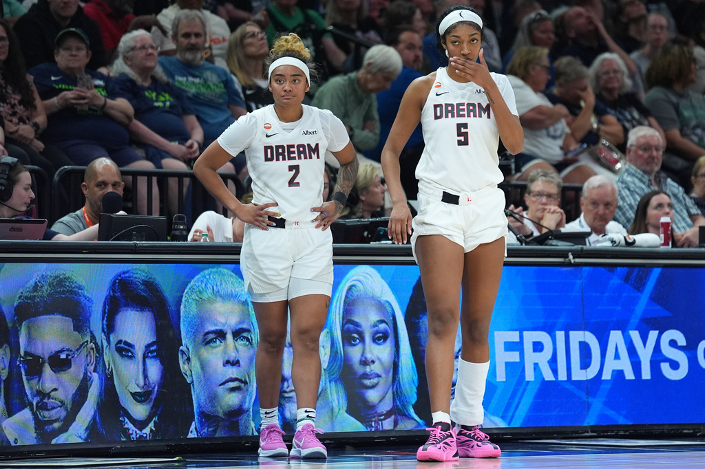 Atlanta Dream guard Te-Hina Paopao (2) and forward Angel Reese (5) wait to check into the game during the first half of a WNBA basketball game against the Minnesota Lynx Wednesday, May 27, 2026, in Minneapolis. (AP Photo/Abbie Parr)