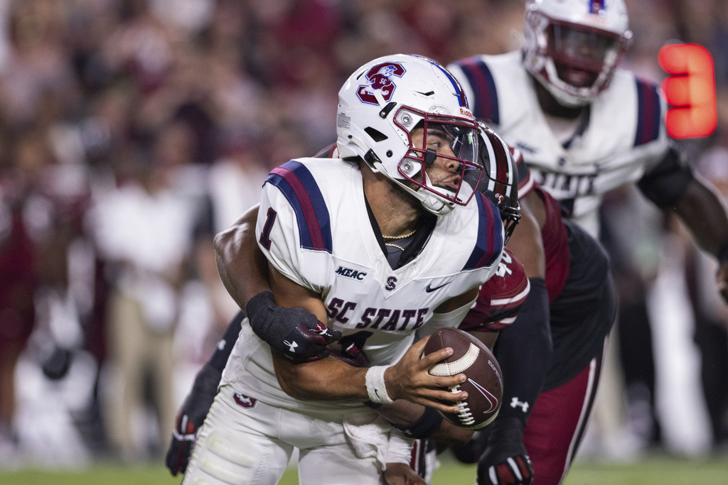 South Carolina State quarterback William Atkins IV (1) is sacked by South Carolina linebacker Bryan Thomas Jr. (46) during the first half of an NCAA college football game Saturday, Sept. 6, 2025, in Columbia, S.C. (AP Photo/Scott Kinser)