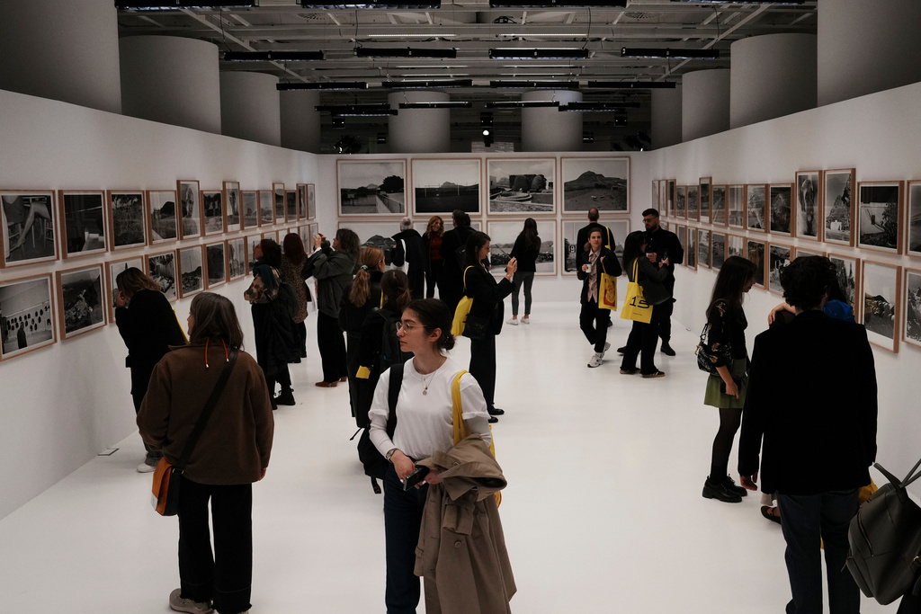Visitors view photographs at an exhibition of images by Oscar nominated director Yorgos Lanthimos at Onassis Stegi in Athens, Greece, on Friday, March 6, 2026. (AP Photo/Thanassis Stavrakis)
