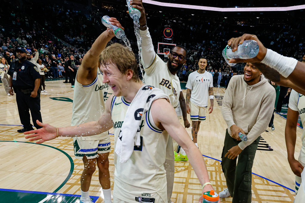 Milwaukee Bucks guard AJ Green (20) is showered with water after an NBA basketball game against the Brooklyn Nets, Friday, April 10, 2026, in Milwaukee. Green set a Bucks franchise record for made three-pointers. (AP Photo/Jeffrey Phelps)