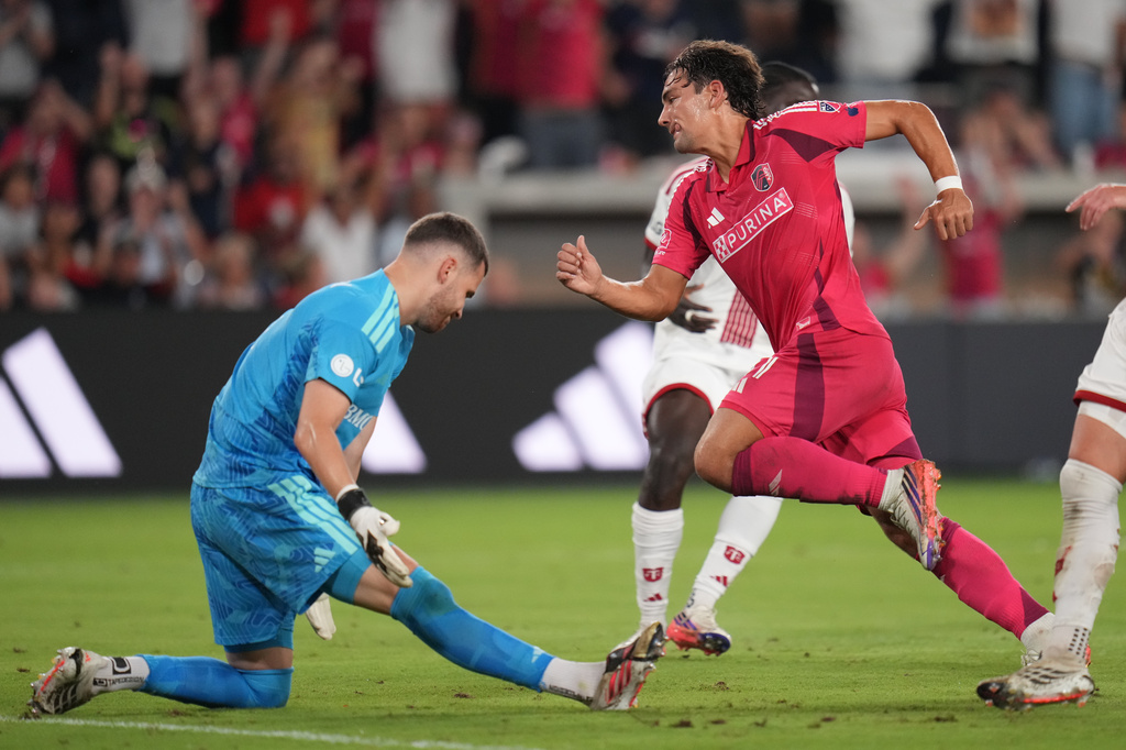 St. Louis City's Simon Becher, right, celebrates after scoring past Toronto FC goalkeeper Luka Gavran, left, during the second half of an MLS soccer match Saturday, Sept. 19, 2026, in St. Louis. (AP Photo/Jeff Roberson)