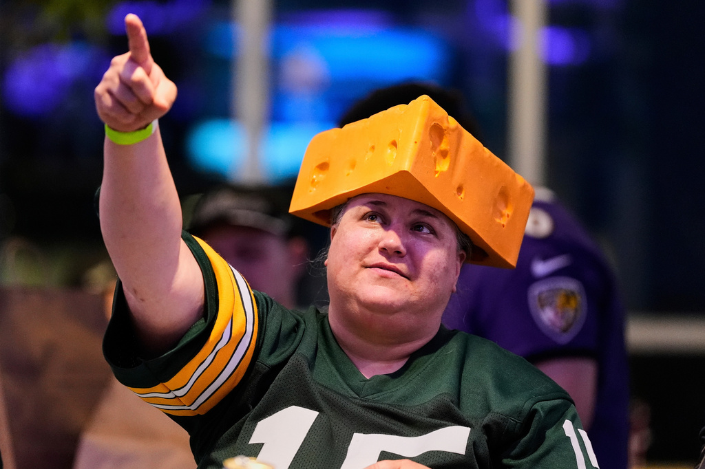 FILE - A Green Bay Packers fan wears a cheesehead hat during a Ravens football draft party at M&T Bank Stadium in Baltimore, April 24, 2025. (AP Photo/Stephanie Scarbrough, File)
