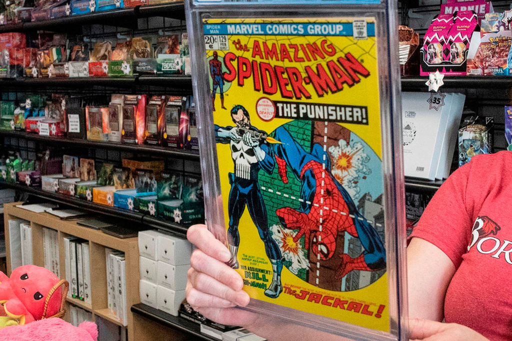 FILE - A game store manager holds the graded AM129 Spiderman "The Punisher" first issue on Sept. 10, 2021, in South Dover, Del. (Marc Clery/Delaware State News via AP, File)