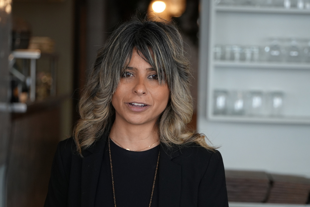 Shayan Ghadimi talks with customers in her restaurant in Paris, Thursday, March 19, 2026. (AP Photo/Alexander Turnbull)