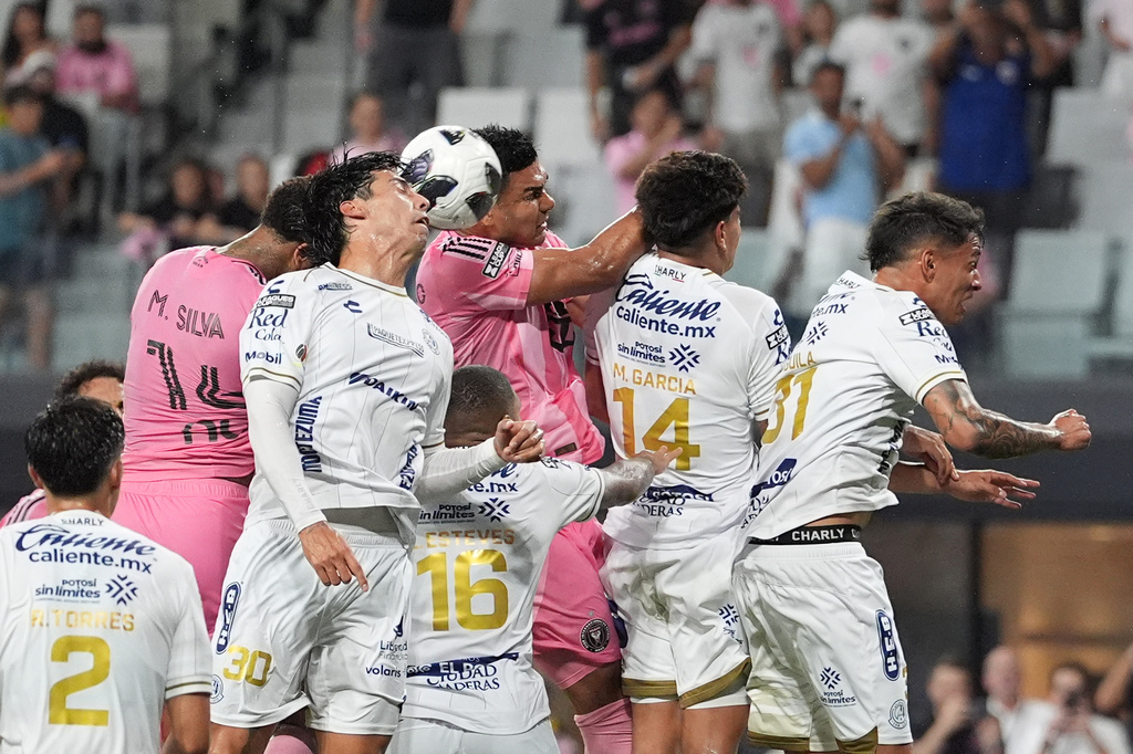 Inter Miami defender Micael (14) heads the ball past Atletico de San Luis defender Benjamin Galindo (30) and Inter Miami midfielder Casemiro (5) to score the team's fourth goal during the first half of a Leagues Cup soccer match, Wednesday, Aug. 5, 2026, in Miami. (AP Photo/Rebecca Blackwell)