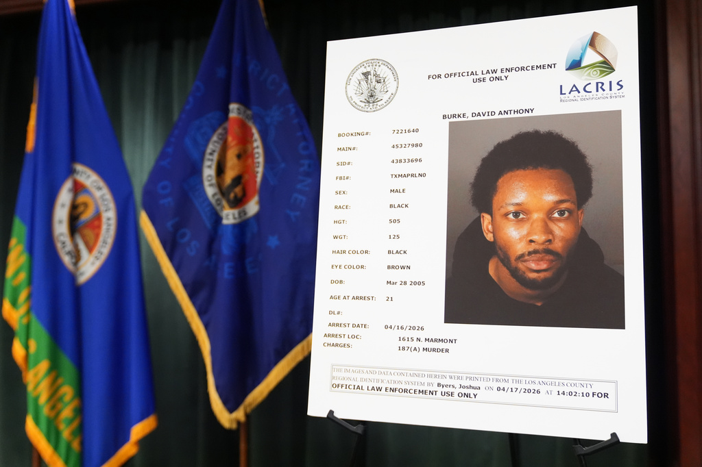 A mugshot of David Anthony Burke, whose stage name is D4vd, is displayed Monday, April 20, 2026, in Los Angeles at a press conference regarding the case of D4vd, who was arrested on suspicion of killing a 14-year-old girl whose dismembered body was found in his car. (AP Photo/Damian Dovarganes)