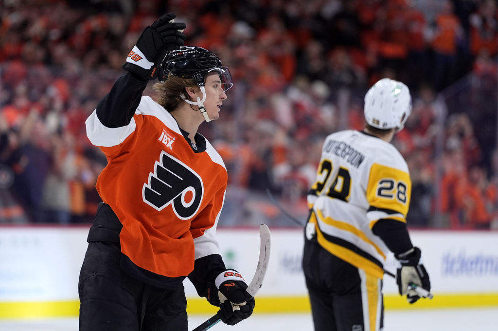 Philadelphia Flyers' Trevor Zegras, left, celebrates past Pittsburgh Penguins' Parker Wotherspoon after scoring a goal during the second period of Game 3 in the first round of the NHL Stanley Cup hockey playoffs Wednesday, April 22, 2026, in Philadelphia. (AP Photo/Matt Slocum)