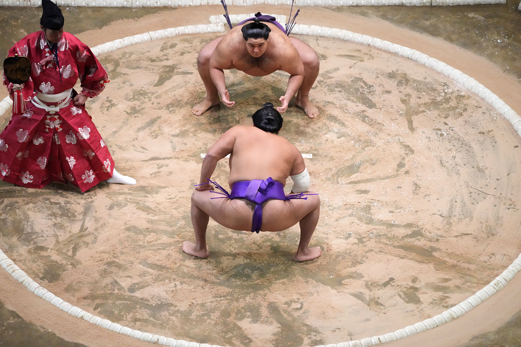 Takerufuji and Roga, top, prepare for their bout at The Grand Sumo Tournament at the Royal Albert Hall in London, Wednesday, Oct. 15, 2025.(AP Photo/Frank Augstein)