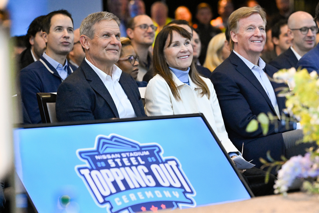 Tennessee Gov. Bill Lee, left, Tennessee Titans team owner Amy Adams Strunk, and NFL Commissioner Roger Goodell, right, listen to remarks during a ceremony celebrating the Titans new stadium's "Steel Topping Out" marking the completion of the building's structural frame signifying the highest point of construction, before raising it into place Friday, Nov. 21, 2025, in Nashville, Tenn. (AP Photo/John Amis)