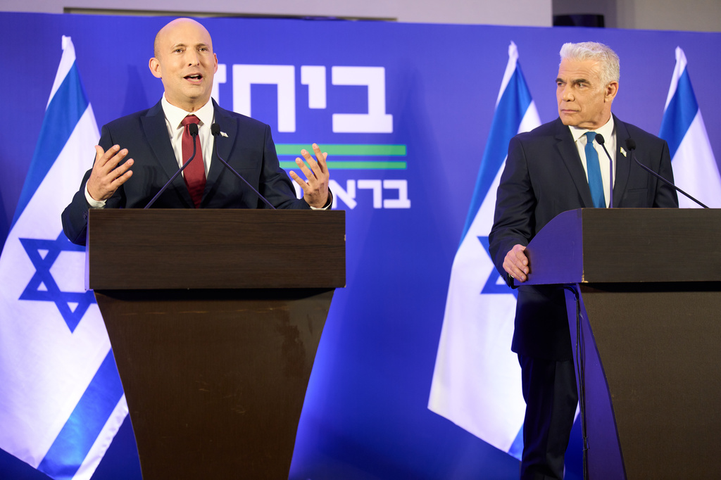 Former Israeli prime ministers Naftali Bennett, left, and Yair Lapid hold a joint press conference announcing that their parties will run together in the upcoming elections, in Herzliya, Israel, Sunday, April 26, 2026. (AP Photo/Ariel Schalit)