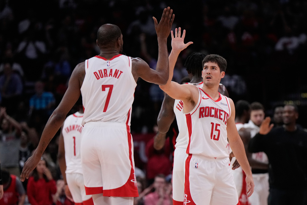 Houston Rockets forward Kevin Durant (7) celebrates with guard Fred Vanvleet (5) during the first half of an NBA basketball game against the Miami Heat in Houston, Saturday, March 21, 2026. (AP Photo/Ashley Landis)