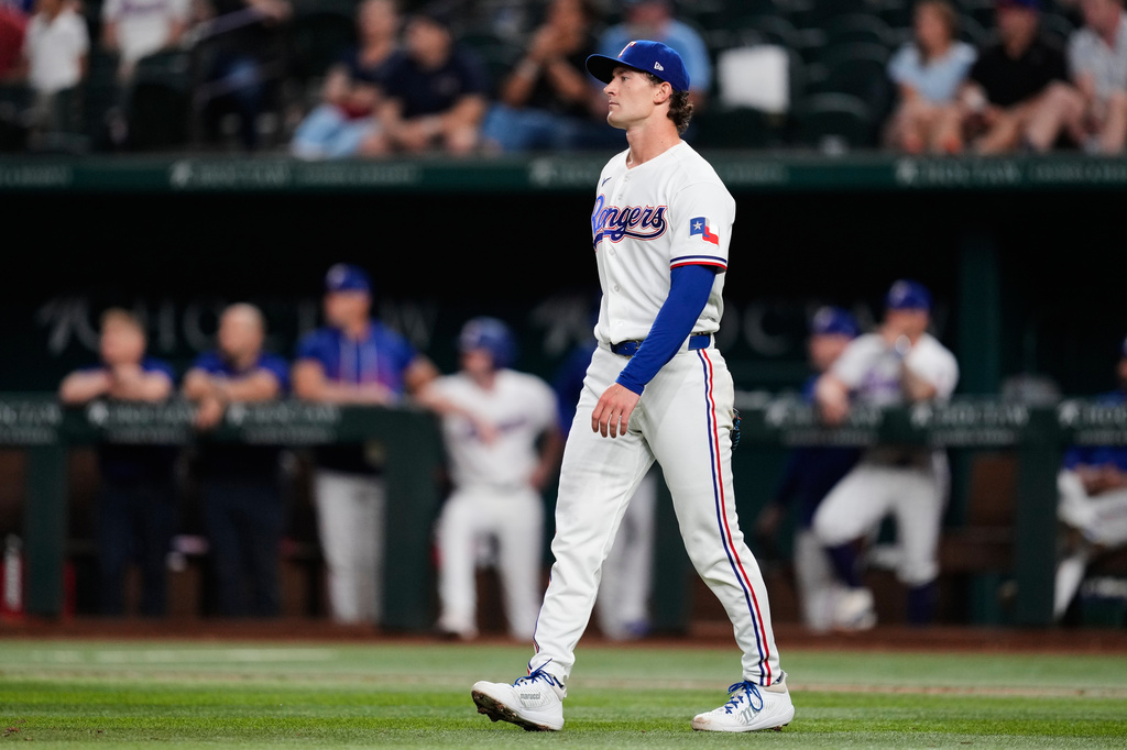 Texas Rangers' Jacob Latz looks on at Arizona Diamondbacks' Nolan Arenado's run-scoring double in the ninth inning of a baseball game Wednesday, May 13, 2026, in Arlington, Texas. (AP Photo/Tony Gutierrez)