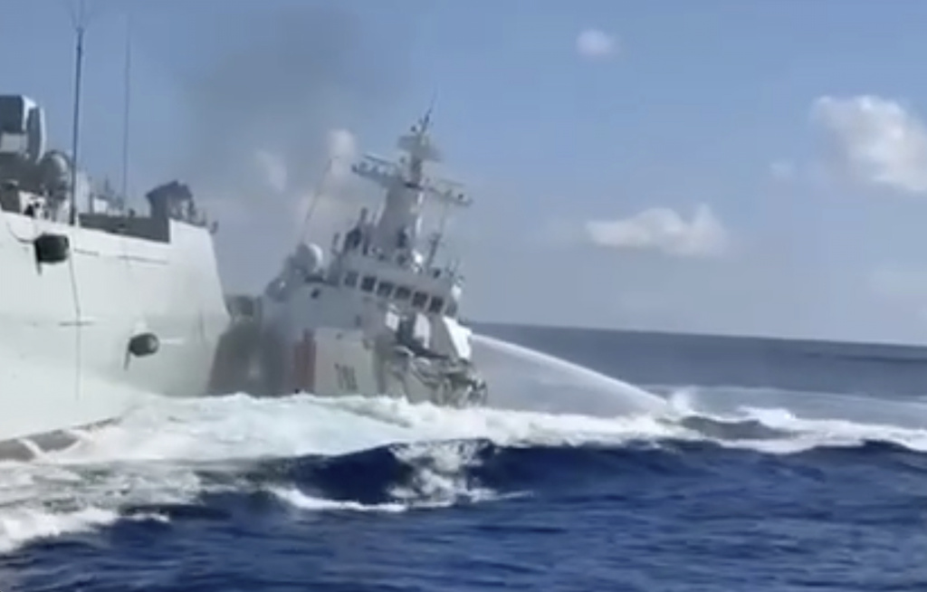 In this photo, taken from video and provided by the Philippine Coast Guard, a damaged Chinese Coast Guard ship, right, is seen beside a Chinese Navy vessel, left, after they accidentally collided while chasing a Philippine fisheries boat near Scarborough Shoal in the disputed South China Sea on Monday Aug. 11, 2025. (Philippine Coast Guard via AP)