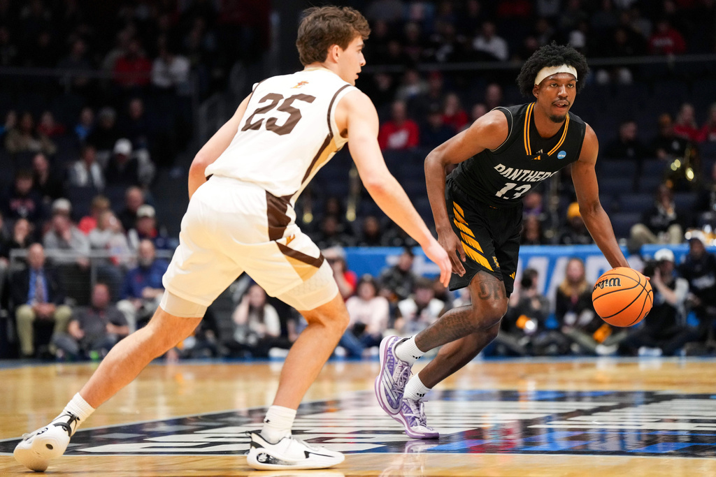 Prairie View A&M forward Cory Wells (13) controls the ball against Lehigh guard Peter Kramer (25) during the first half of a First Four college basketball game in the NCAA Tournament in Dayton, Ohio, Wednesday, March 18, 2026. (AP Photo/Jeff Dean)