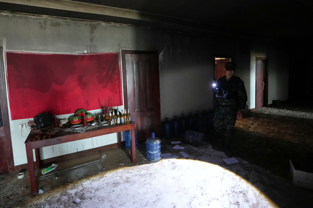 A Thai soldier inspects a scam center in O'Smach, Cambodia, Monday, Feb. 2, 2026, (AP Photo/Sakchai Lalit)