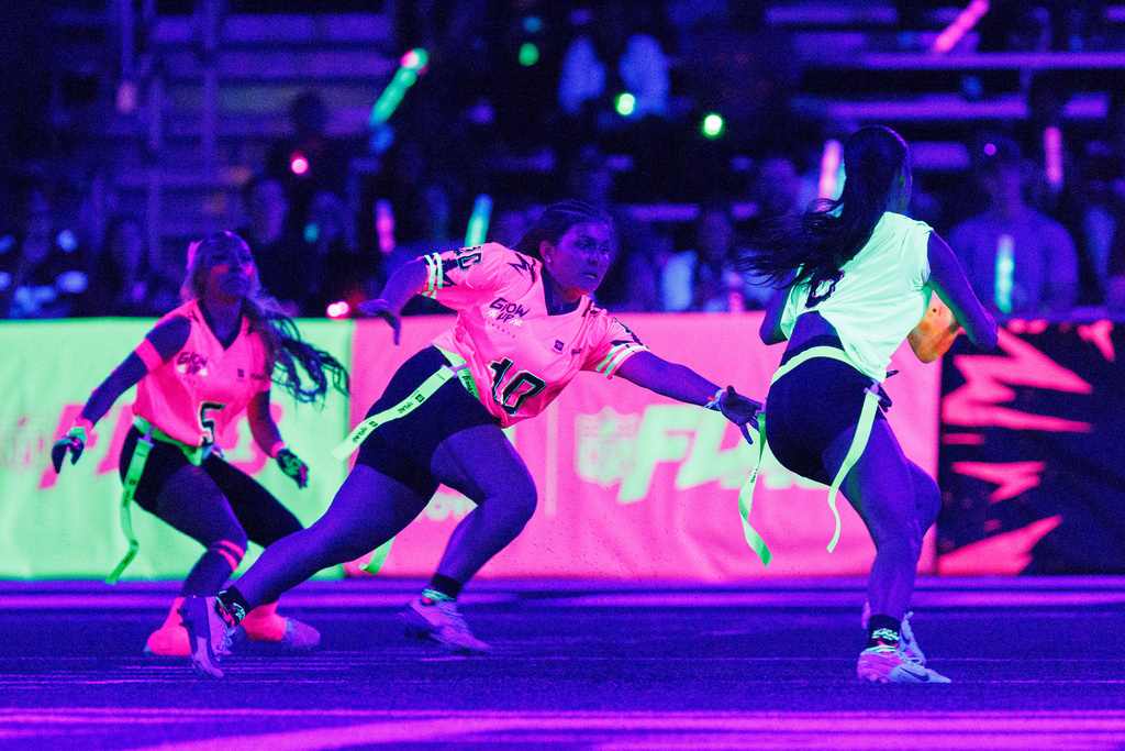 Team Pink's Riley Harrington (10) of Amador Valley High School, challenges Team Green's Ryleigh Longaker (6) of Sacred Heart Prep during the Toyota Glow-Up Classic flag football game in San Francisco on Wednesday, Feb. 4, 2026. (Santiago Mejia/San Francisco Chronicle via AP)
