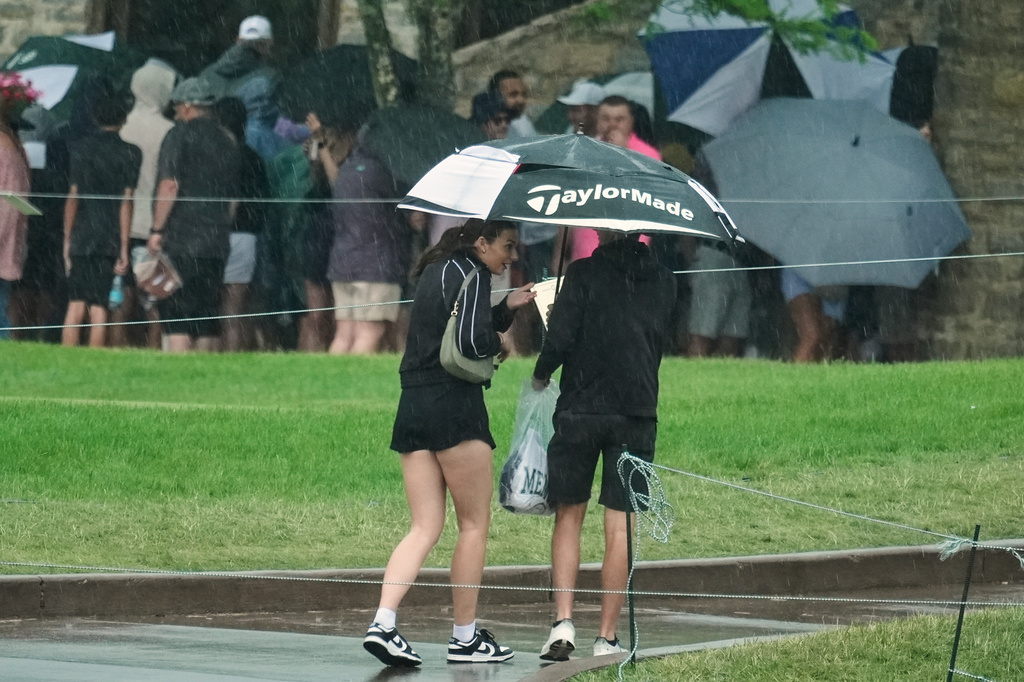 Fans exit Muirfield Village Golf Club as severe weather moves in during the third round of the Memorial golf tournament, Dublin, Ohio, Saturday, June 6, 2026. (AP Photo/Sue Ogrocki)