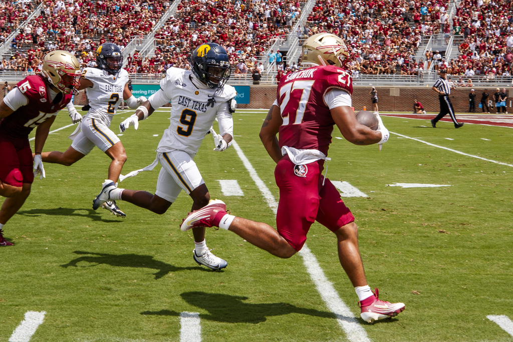 Florida State running back Gavin Sawchuk (27) runs for a touchdown as East Texas A&M defensive back Josh Wiggins (9) pursues during the first half of an NCAA college football game, Saturday, Sept. 6, 2025, in Tallahassee, Fla. (AP Photo/Colin Hackley)