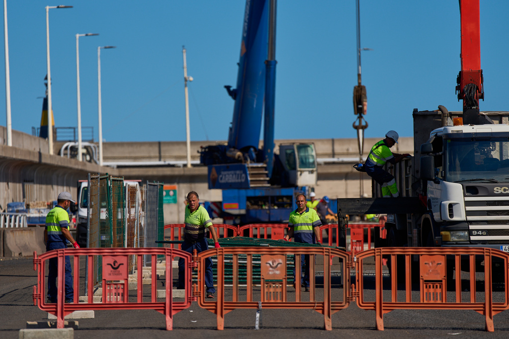 Workers prepare the area where passengers from the MV Hondius cruise ship are expected to arrive at the port of Granadilla in Tenerife, Canary Islands, Spain, Friday, May 8, 2026. (AP Photo/Manu Fernandez)