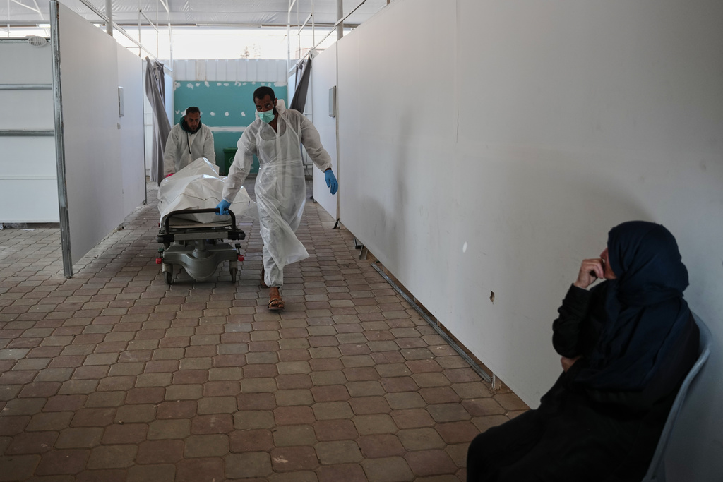 Bodies of unidentified Palestinians returned from Israel as part of the ceasefire deal are brought to Nasser Hospital in Khan Younis, Gaza Strip, Saturday, Nov. 8, 2025. (AP Photo/Abdel Kareem Hana)