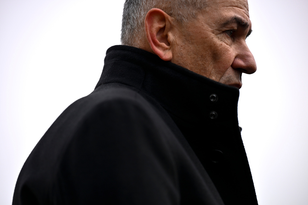Former Slovenian Prime Minister Janez Jansa speaks to the media outside a polling station for parliamentary elections in Arnace, Slovenia, Sunday, March 22, 2026. (AP Photo/Denes Erdos)