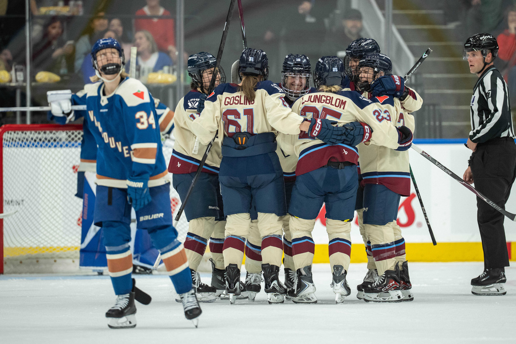 Montreal Victoire's Hayley Scamurra (16) celebrates her goal with her teammates as Vancouver Goldeneyes' Hannah Miller (34) skates to the bench during the third period of a PWHL hockey game, in Vancouver, on Tuesday, April 21, 2026. (Ethan Cairns/The Canadian Press via AP)