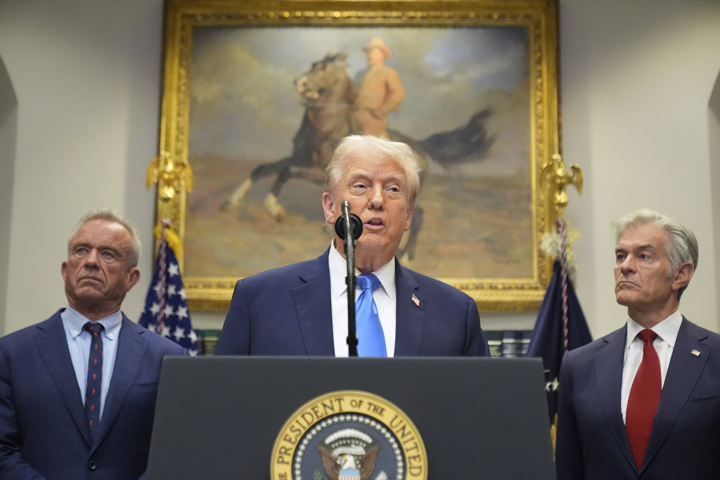 President Donald Trump speaks in the Roosevelt Room of the White House, Monday, Sept. 22, 2025, in Washington, as Health and Human Services Secretary Robert F. Kennedy Jr., left, and Centers for Medicare & Medicaid Services administrator Dr. Mehmet Oz listen. (AP Photo/Mark Schiefelbein)