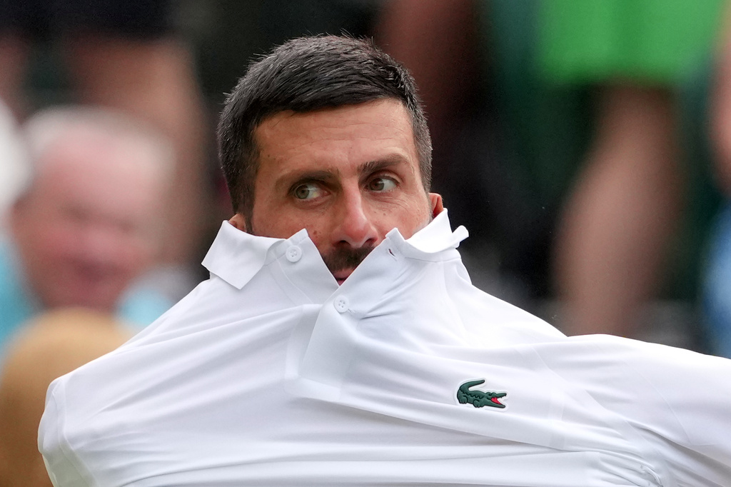 Novak Djokovic of Serbia changes his shirt during the men's singles match against Yibing Wu of China at the Wimbledon Tennis Championships in London, Monday, June 29, 2026.(AP Photo/Kin Cheung)