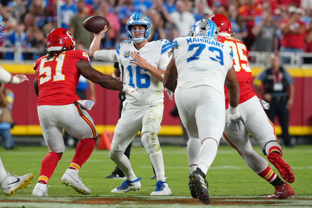 Detroit Lions quarterback Jared Goff (16) throws under pressure from Kansas City Chiefs defensive end Mike Danna (51) during the first half of an NFL football game Sunday, Oct. 12, 2025, in Kansas City, Mo. (AP Photo/Ed Zurga)