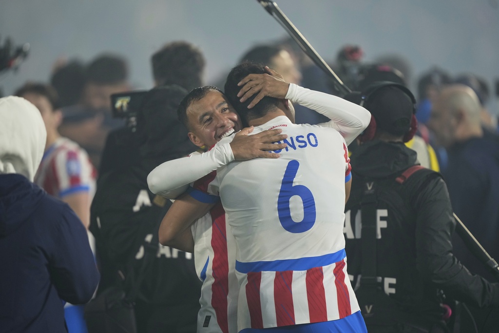 Paraguay's Alejandro Gamarra, back, and Junior Alonso embrace after qualifying for the FIFA World Cup 2026 after their match against Ecuador at Defensores del Chaco in Asuncion, Paraguay, Thursday, Sept. 4, 2025. (AP Photo/Jorge Saenz)