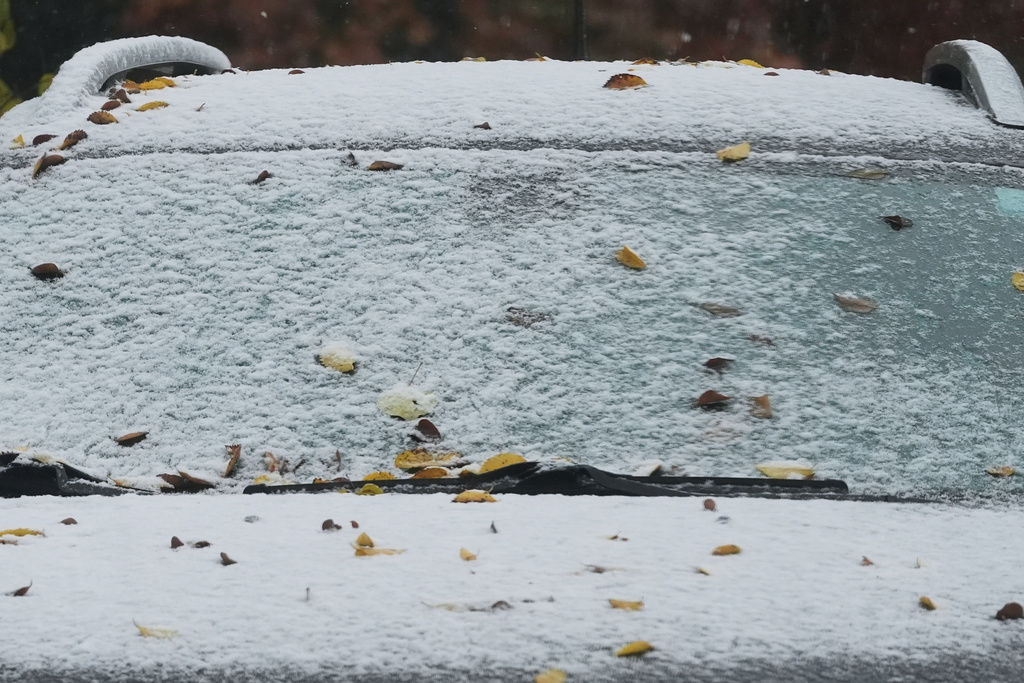 A car is covered with snow during a cold day in Evanston, Ill., Sunday, Nov. 9, 2025. (AP Photo/Nam Y. Huh)