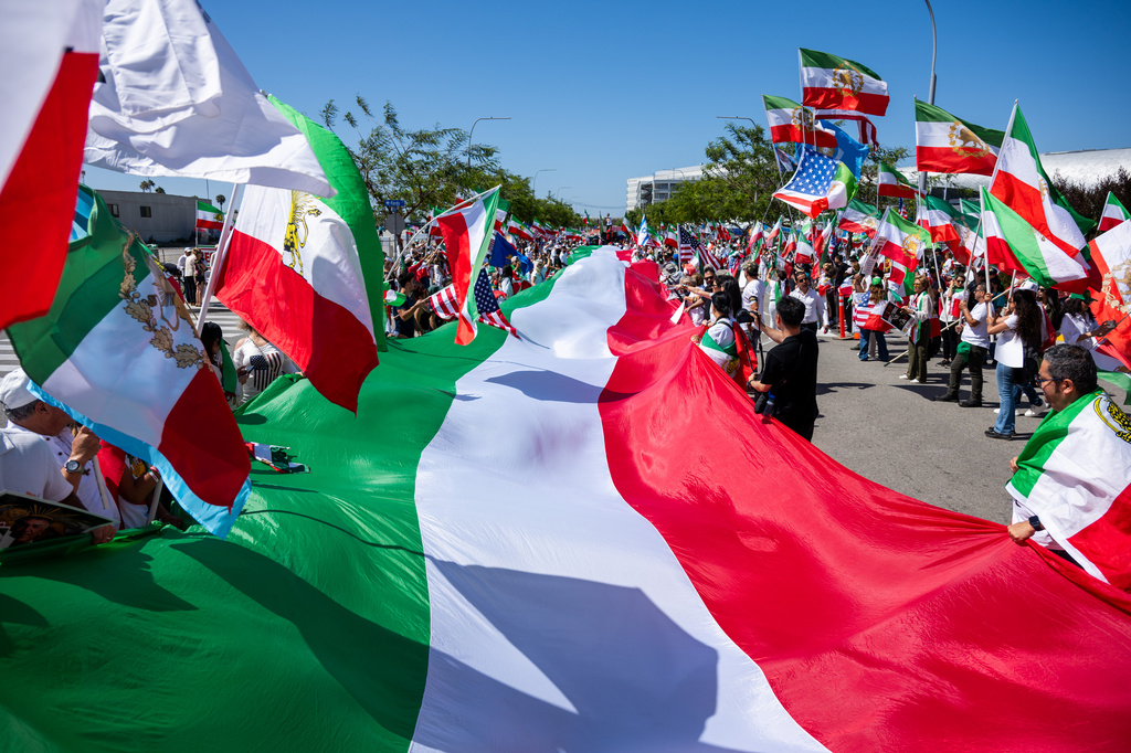 People carry a giant Iranian flag during a protest in reaction to FIFA's ban of Iran's pre-revolutionary flag inside World Cup stadiums Sunday, June 7, 2026, in Inglewood, Calif. (AP Photo/Benjamin Hanson)