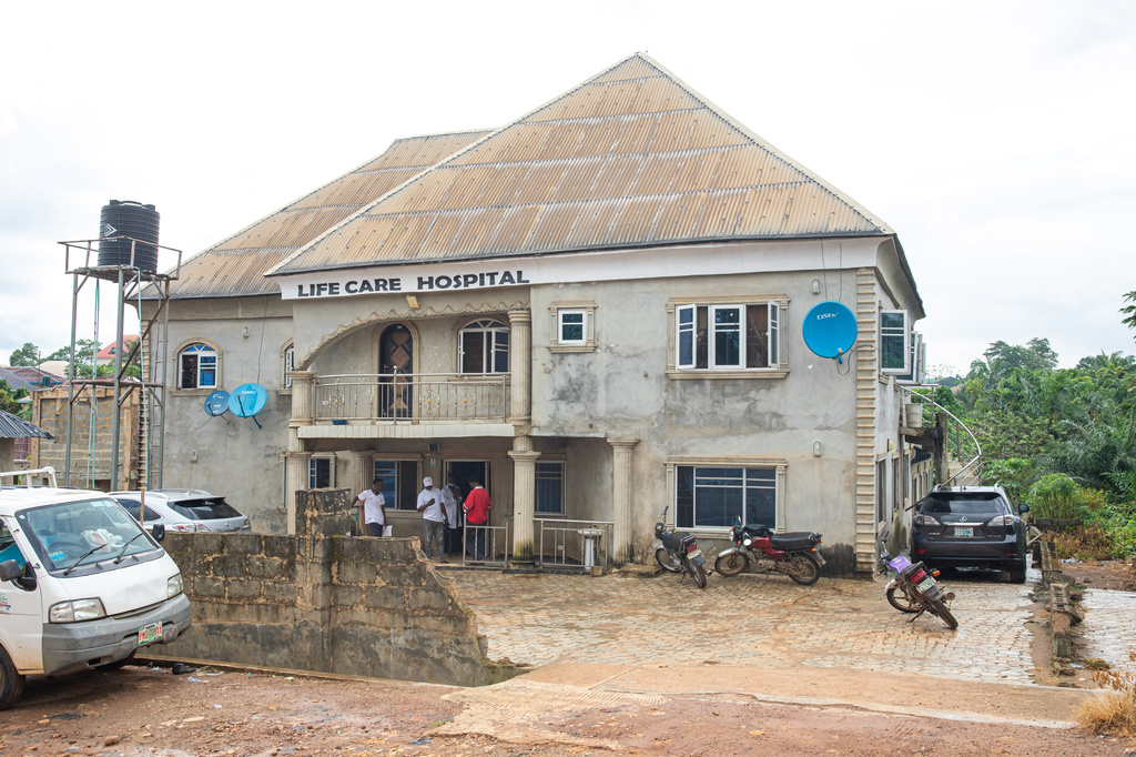 People stand at a door to the hospital were victims of a locally brewed alcoholic concoction commonly known as "Monkey Tail" are receiving treatment in Odigbo southern Nigeria, Thursday, Sept. 17, 2026. (AP Photo/Dapo Alley)