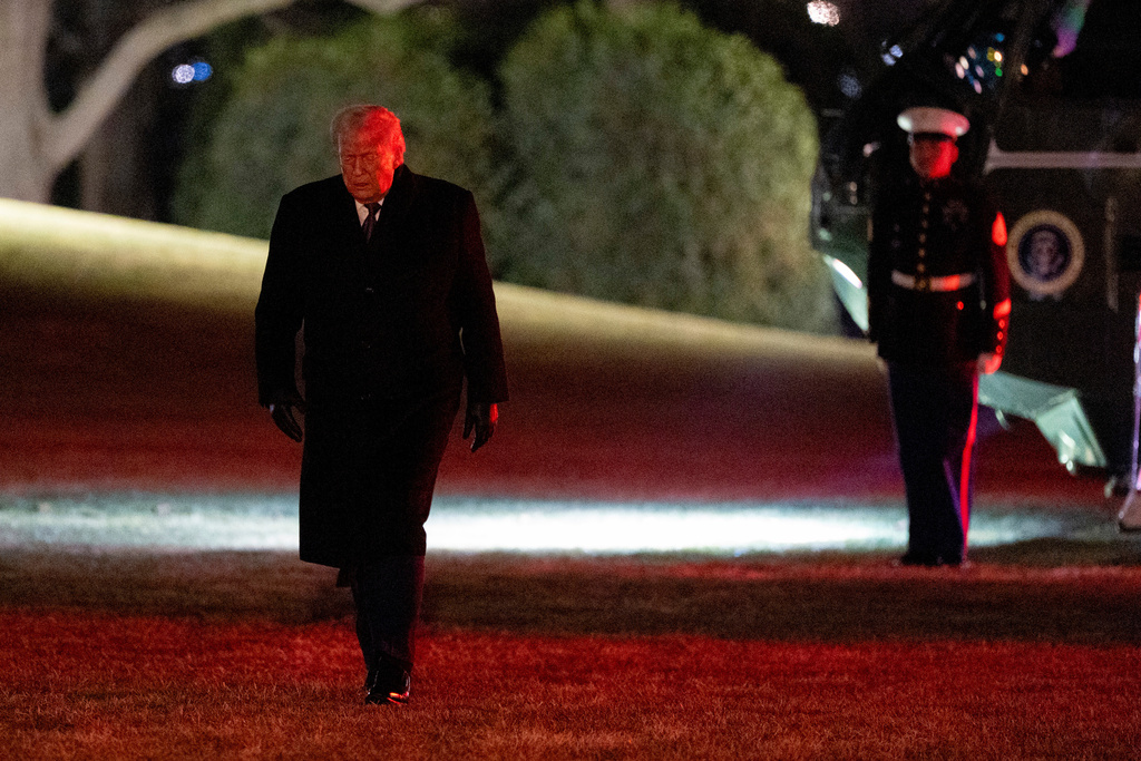 President Donald Trump walks from Marine One after arriving on the South Lawn of the White House, Thursday, Jan. 22, 2026, in Washington. (AP Photo/Alex Brandon)