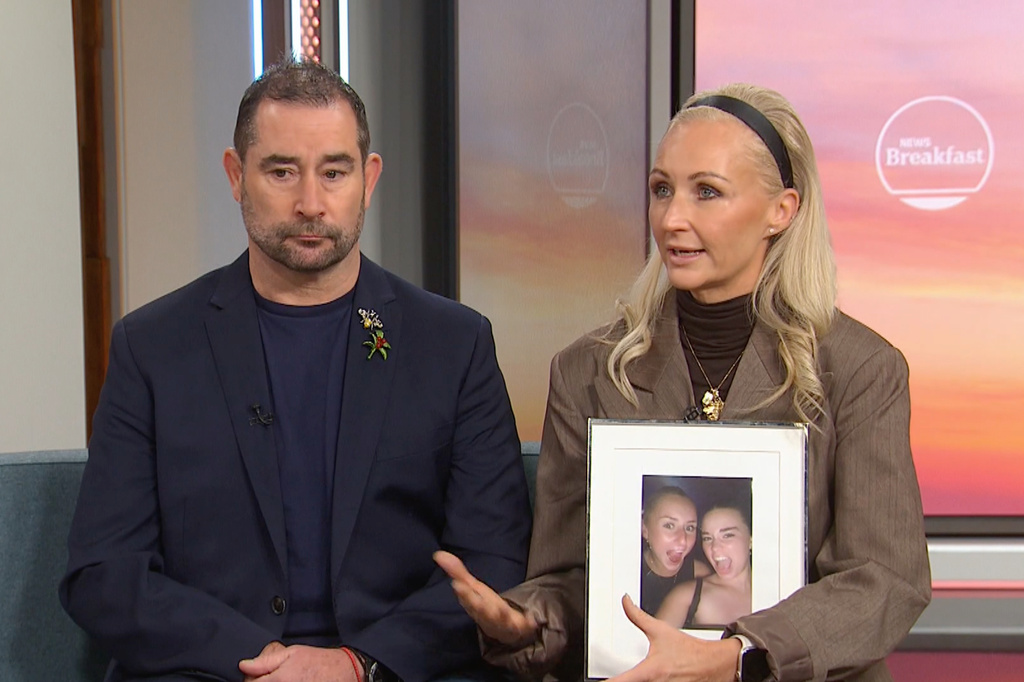 In this image made from video Michelle Jones, right, holds a photo of her daughter, Bianca, as Michelle and her husband Mark Jones appear on a news program in Melbourne, Australia, Friday, July 17, 2026. (Australian Broadcasting Corp via AP)