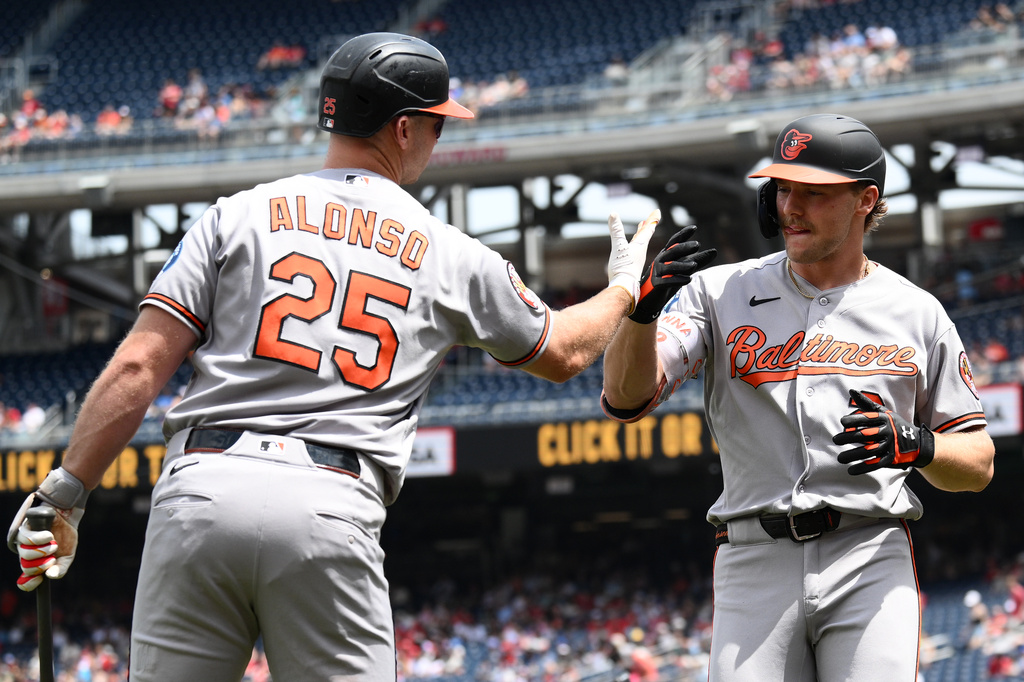 Baltimore Orioles' Gunnar Henderson, right, celebrates his home run with Pete Alonso (25) during the first inning of a baseball game against the Washington Nationals, Sunday, May 17, 2026, in Washington. (AP Photo/Nick Wass)