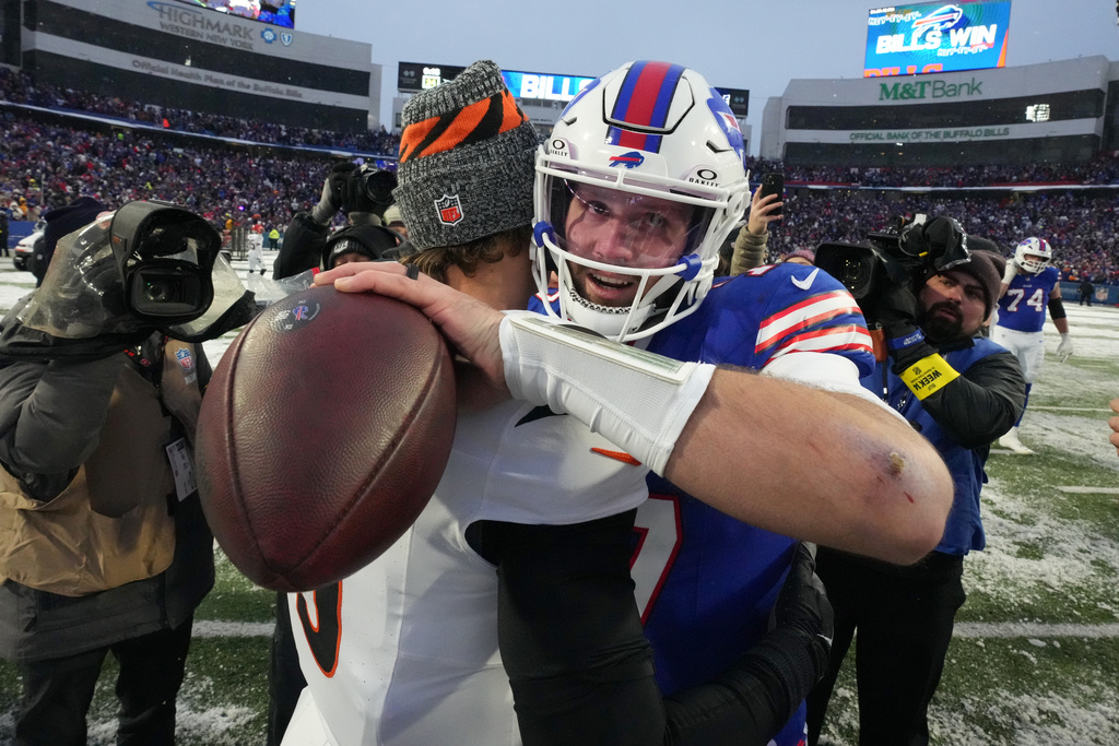 Buffalo Bills quarterback Josh Allen, right, embraces Cincinnati Bengals quarterback Joe Burrow after an NFL football game, Sunday, Dec. 7, 2025, in Orchard Park, N.Y. (AP Photo/Gene J. Puskar)