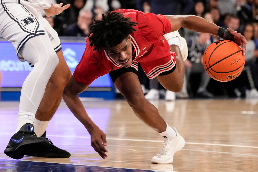 Texas Tech guard Christian Anderson falls after driving past Duke guard Cayden Boozer, left, during the second half of an NCAA college basketball game, Saturday, Dec. 20, 2025, in New York. (AP Photo/Yuki Iwamura)