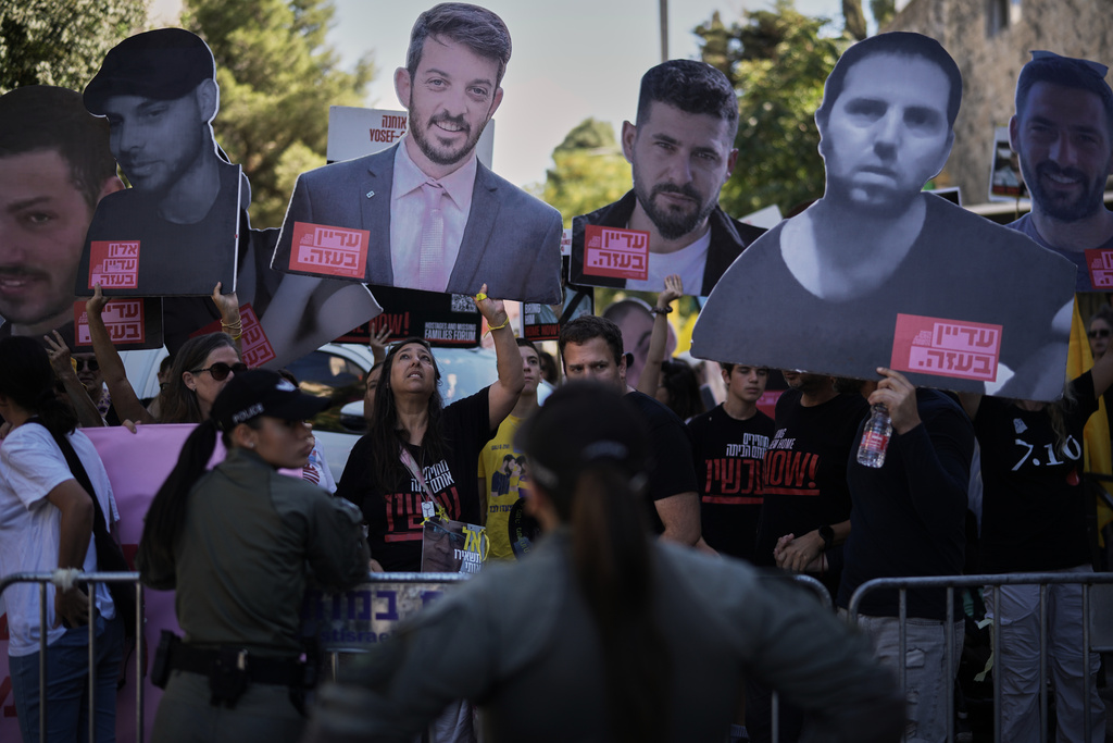 Relatives and supporters of Israeli hostages held by Hamas in the Gaza Strip carry posters with portraits of their loved ones during a protest demanding their immediate release and calling for a ceasefire, in Jerusalem, Tuesday, Oct. 7, 2025, on the second anniversary of Hamas' cross-border attack on Israel on Oct. 7, 2023, which sparked the ongoing war in Gaza. (AP Photo/Leo Correa)