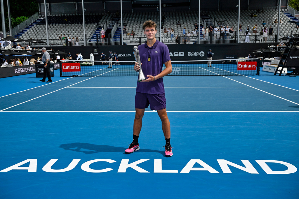 Jakub Mensik of the Czech Republic poses with his trophy after defeating Sebastian Baez of Argentina in the men's singles final of the ASB Classic in Auckland, New Zealand, Saturday, Jan. 17, 2026. (Alan Lee/ Photosport via AP)